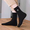 Chaussette haute unie avec marguerite brodée.