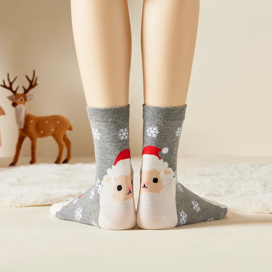 Chaussettes grises de noël motif flocons et tête de mouton portant un bonnet de noël