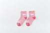 Chaussettes montantes, fond rose, motif  licornes. Pour bébé et enfant (du 12 mois au 12 ans).
