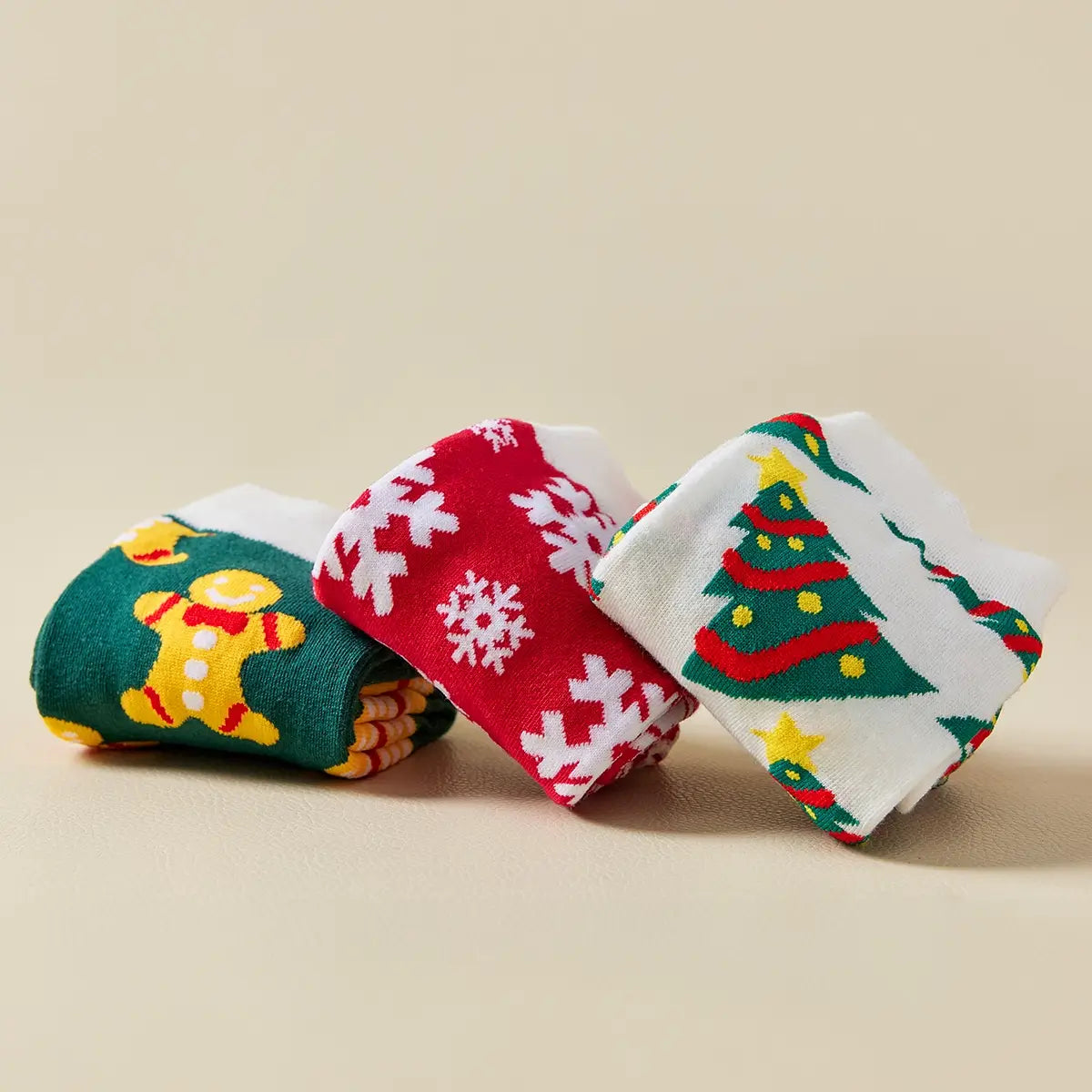 Chaussettes hautes de Noël avec motifs festifs : sapin, flocon, biscuit. Douces, chaudes et stylées pour un hiver cosy et un look joyeux à Noël.