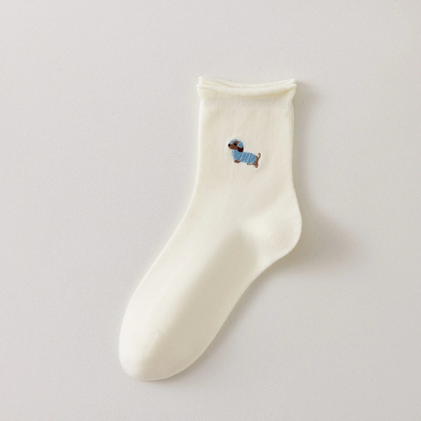 Chaussette femme crème vendue à l’unité avec broderie chien ou chat. Maille douce, bord roulotté et taille unique 35-41. Confort et fantaisie garantis.
