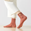 Chaussette haute chaude avec cœur doré brodé.