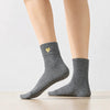 Chaussette haute chaude avec cœur doré brodé.