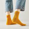 Chaussette haute unie avec cœur rouge brodé au talon.
