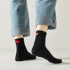 Chaussette haute unie avec cœur rouge brodé au talon.