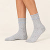 Chaussettes hautes chinées à double feston vendues à l’unité en bleu, gris ou beige. Matière douce et stretch, taille 35-41, pour un style féminin.