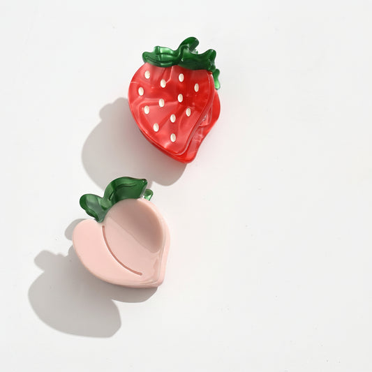 Lot de 2 pinces motifs fruits, taille environ 3 cm. Accessoires cheveux légers et pratiques, idéals pour maintenir une mèche au quotidien.