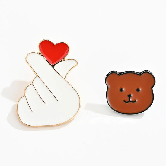 Lot de 2 pin's : tête d'ours marron et signe main coeur coréen blanc et rouge