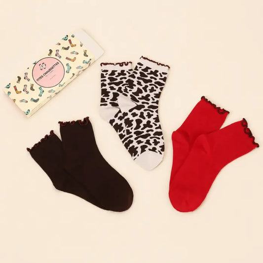 Lot de 3 chaussettes hautes femme motif vache & feston : un trio tendance avec 1 paire fantaisie et 2 paires unies rouge et marron. Taille unique 35-41.