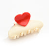 Pince cheveux cœur ivoire et rouge en acétate, 5,5 cm. Accessoire coiffure élégant et pratique, idéal pour cheveux fins à mi-longs.